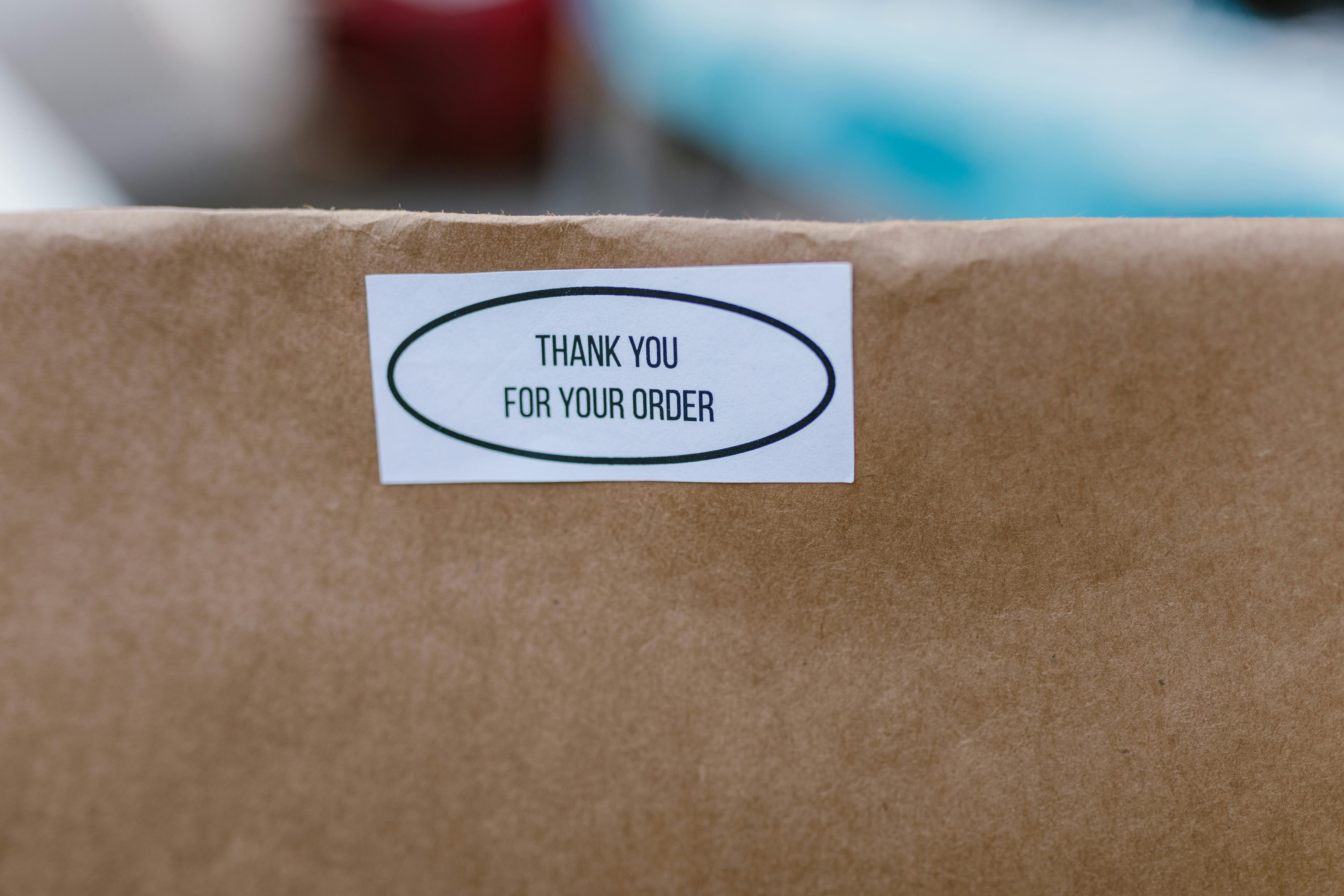 Shipment carton with a thank-you order sticker ready for dispatch.